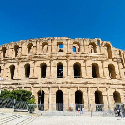 Historic Roman amphitheatre in El Djem, Tunisia, under a clear blue sky.