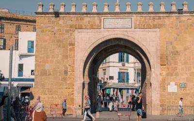 Explore the iconic Bab El Bhar city gate in Tunis, showcasing historical architecture and vibrant street life.