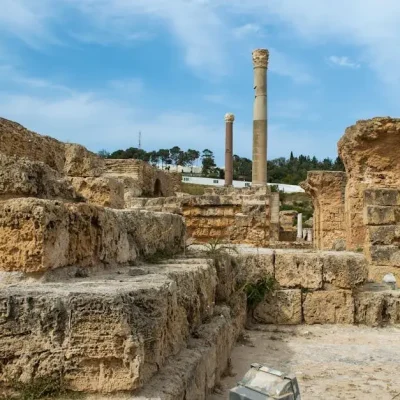 Explore the ancient ruins of Carthage, capturing historic structures and weathered stones under a bright sky.